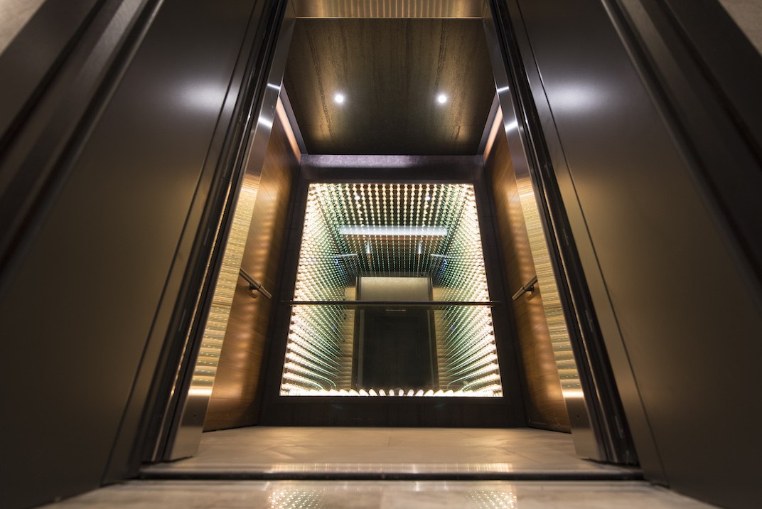 An elevator with lights in the middle Description automatically generated